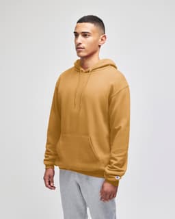A man wearing a mustard yellow pullover hooded sweatshirt with a pouch pocket and a logo.