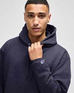 A dark navy pullover hooded sweatshirt with a front pouch pocket and a logo on the sleeve.