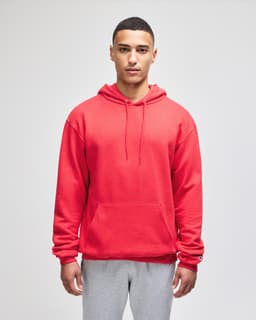 A red pullover hooded sweatshirt with a front pocket and a brand logo, worn by a model.