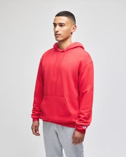 A red pullover hooded sweatshirt with a front pocket and a logo on the sleeve.