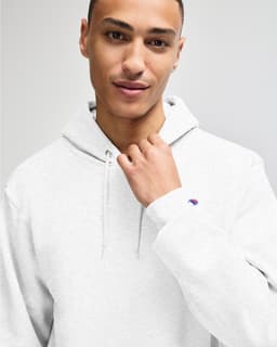A grey hooded sweatshirt with a front pouch pocket and a brand logo on the sleeve.
