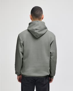 A grey pullover hooded sweatshirt with a relaxed fit, featuring a large hood and long sleeves, viewed from the back.