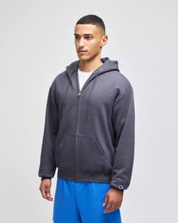 A grey full-zip hooded sweatshirt worn by a model, featuring a hood and front pockets. The model is also wearing blue shorts.