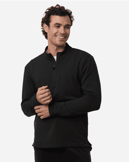 A man wearing a black stretch fleece 1/4 zip top with a smile, featuring a logo on the chest.