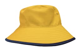 A yellow reversible bucket hat with a navy blue brim and a logo on the side.