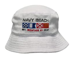 A white terry towelling bucket hat featuring decorative nautical flags and an embroidered logo.