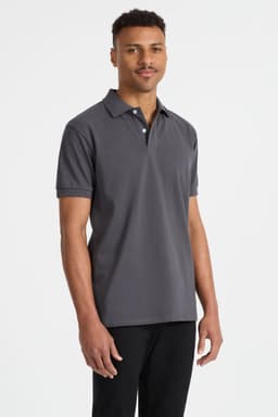 A men's polo shirt in grey, featuring a collar and short sleeves, displayed on a model. The shirt includes a logo.