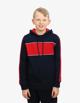 A navy and red hoodie featuring a striped design and a hood. The model is smiling and standing against a plain background.