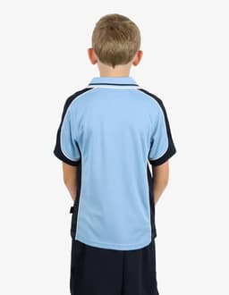 A boy is wearing a blue and black polo shirt, viewed from the back, featuring a logo on the sleeve.