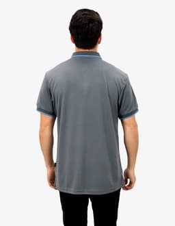 A grey polo shirt featuring blue accents, viewed from the back, with a logo displayed.
