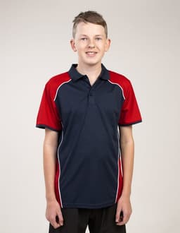 A young person wearing a navy and red polo shirt featuring a logo, with short sleeves and a collar.
