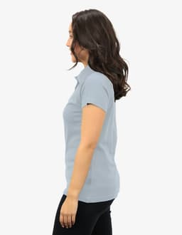 Polo shirt in light blue, displayed on a model from the side, featuring a logo on the chest.