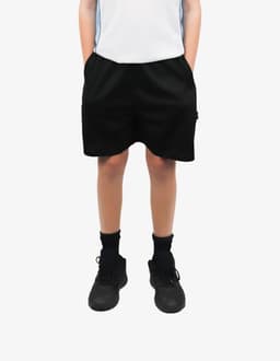 Black sports shorts with pockets, showcased on a model wearing a light top and black footwear. The product has a logo.
