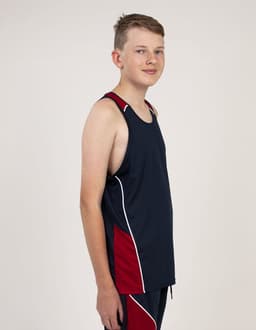 A young person wearing a navy blue and red singlet with contrasting white detailing and a logo.