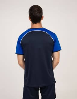 A man is wearing a navy blue and blue T-shirt with a sporty design and a logo on the back.