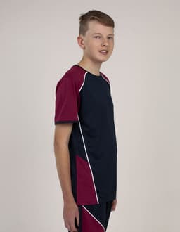 A youth model wearing a navy and maroon T-shirt with white accents and a logo.