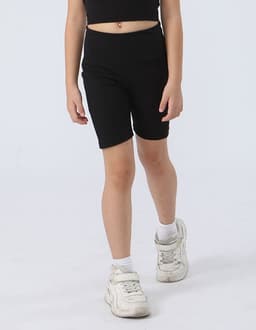 Black girl's legging shorts with a fitted design, paired with white sneakers, set against a light background.