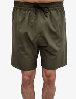Olive green sports shorts featuring an elastic waistband and side pockets, with a logo present on the garment.