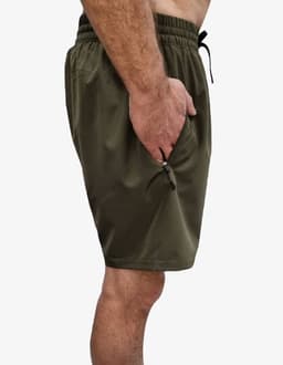 Sports shorts in olive green with a drawstring waist and a zippered side pocket. Features a logo.
