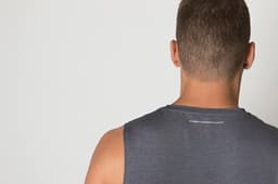 A grey singlet shirt is displayed, featuring a subtle logo at the back and a smooth fabric texture.