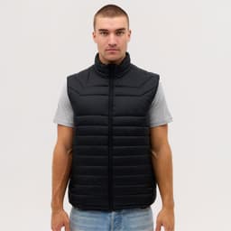 A black puffer vest with a high collar, featuring a quilted design, displayed on a model.