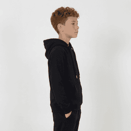A black youth hoodie is displayed, featuring a hood and a kangaroo pocket. The model is a child with curly hair.