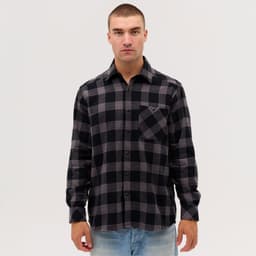 A long sleeve flannel shirt featuring a black and grey check pattern, with a pocket and a branded logo.