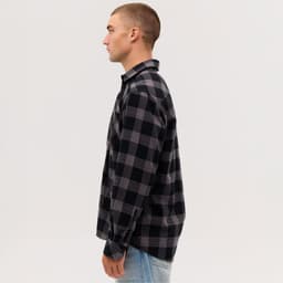 A long sleeve flannel shirt in black and grey check patterns, featuring a button-up design and a collar.