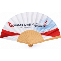 A wooden hand fan with a red and white design, featuring an airline logo and an image of an airplane.
