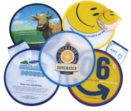 A collection of colourful foldable nylon fun flyers, featuring smiley faces and various designs, with one logo visible.