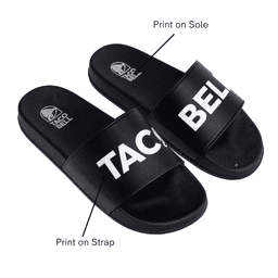 A pair of black PVC slides featuring a prominent logo and text printed on the strap and sole.