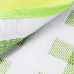 A green and white checkered picnic blanket with a textured surface and a soft lining along the edge, featuring a logo.