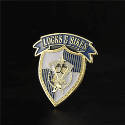 A custom enamel lapel pin featuring a gold and blue shield design with decorative elements and a logo.