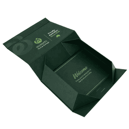 A green magnetic gift box with a ribbon, featuring an interior welcome message and a logo on the exterior.
