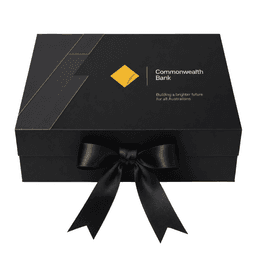 A large black gift box with a ribbon, featuring a logo and modern design elements.