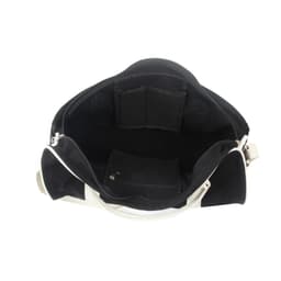 An open black and white duffle bag showcasing multiple interior pockets and compartments.