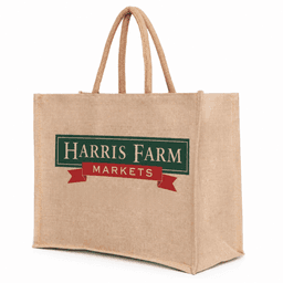 A large, natural-coloured juco bag with sturdy handles and a logo on one side.