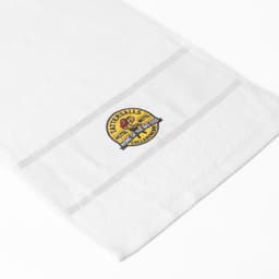 A large white cotton gym towel with a circular logo featured prominently on the side.