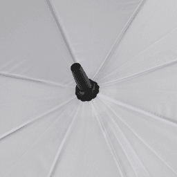A white golf umbrella viewed from above, featuring a central black shaft and multiple panels. It has a branding logo.