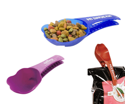 A blue and a purple pet food clip scooper with kibble, alongside a red scooper, placed near a pet food bag.