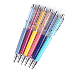A collection of metal ballpoint pens in blue, yellow, pink, and turquoise with decorative crystals in the barrel.