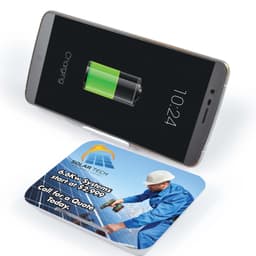 A wireless charger with a sleek design and a smartphone on top displaying a battery charging icon.