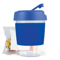 A reusable coffee cup with a blue silicone sleeve and matching lid, accompanied by a package of colorful jelly beans.