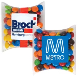 A pillow pack containing colorful M&M's chocolate candies, featuring a branding logo on one side.