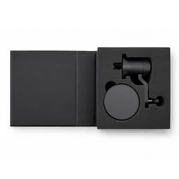 A black car phone holder with a mount, displayed inside a black packaging box. The product includes a holder and a base.