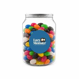 A clear jar filled with assorted jelly beans in vibrant colours, featuring a label with a logo.