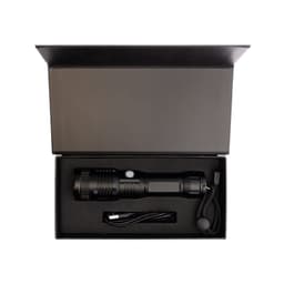 A black rechargeable torch in a black box with a USB charging cable and a lanyard. The box is open.