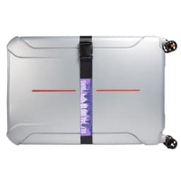 A silver suitcase secured with a black luggage strap, featuring a colorful logo.
