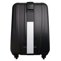 A black suitcase featuring a luggage strap across its surface for secure fastening.