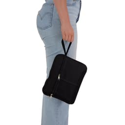 A black utility pouch with a handle, held by a person wearing light blue jeans. It features a zip closure.